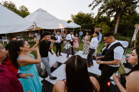 Grupo de personas baila junto a la piscina durante la celebración.