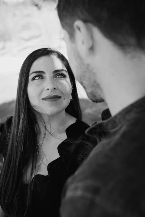 Mujer mirando al hombre en un retrato cercano en blanco y negro.